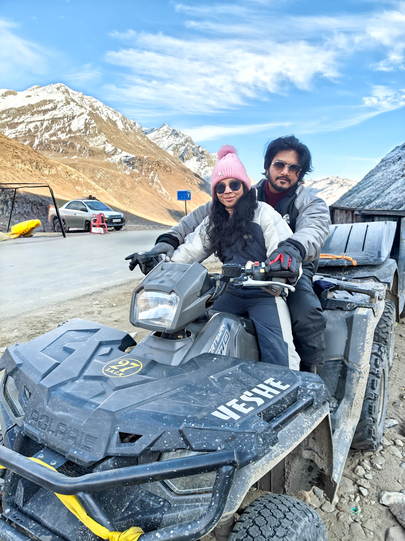 Pooja and Yuvaraj riding an ATV in the mountains