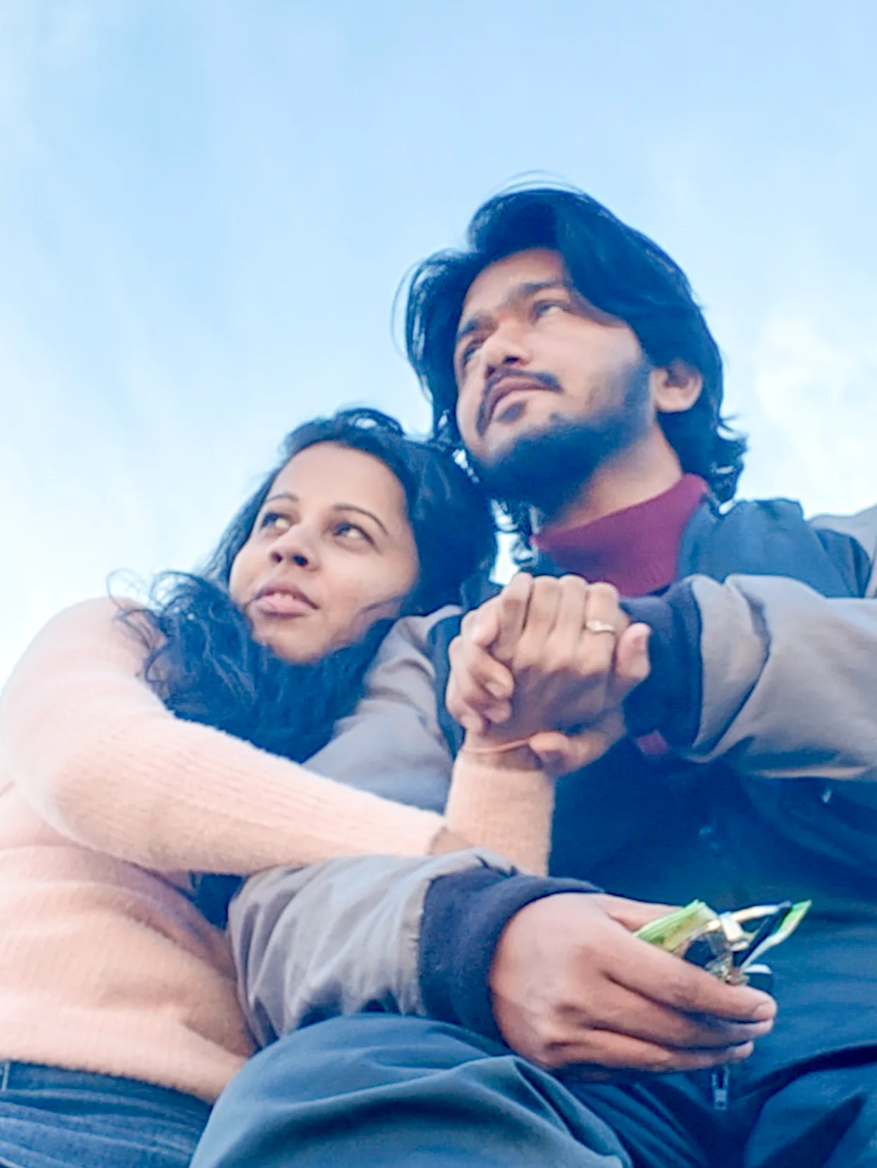 Pooja and Yuvaraj sitting together in a quiet portrait