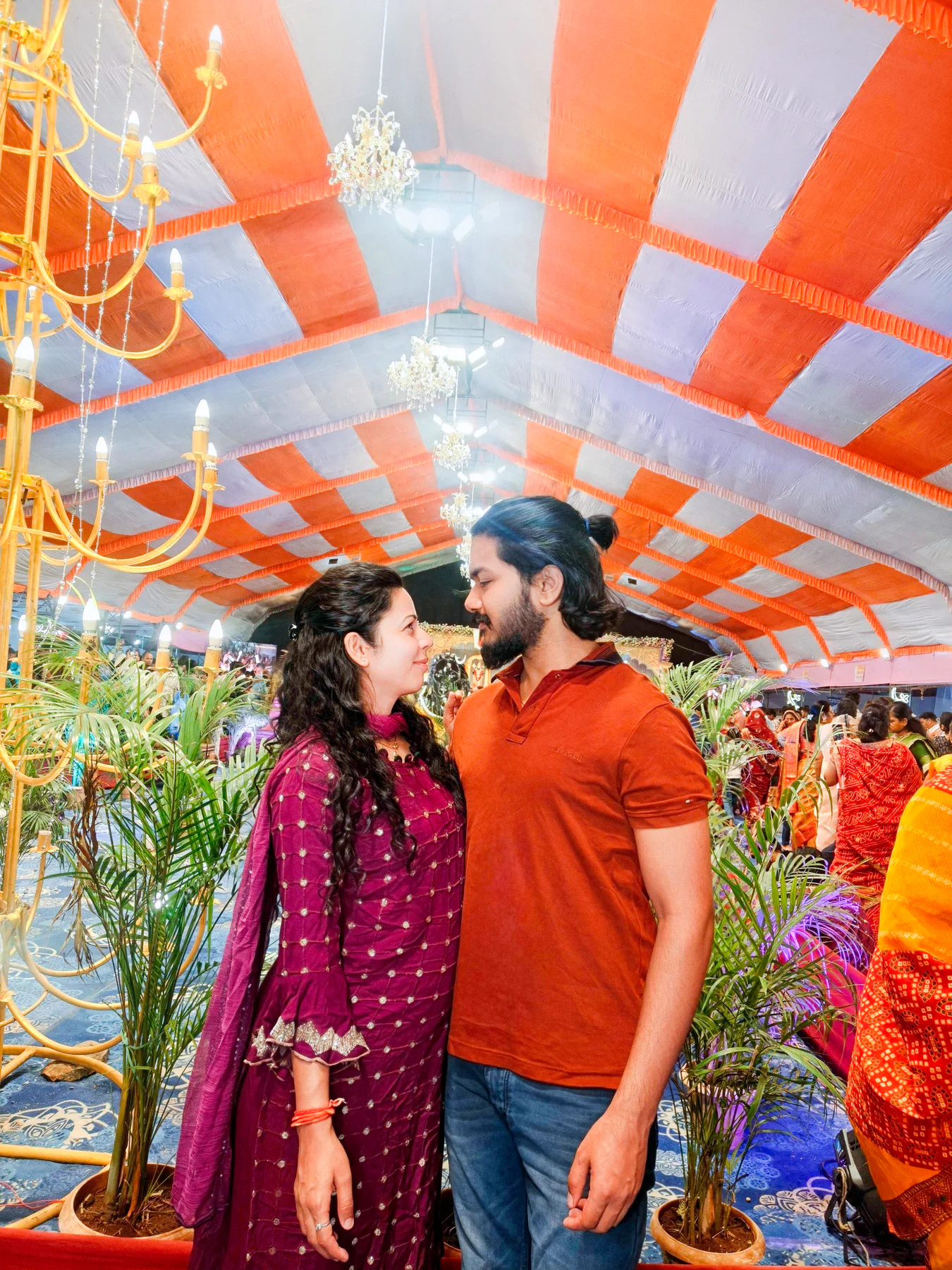 Pooja and Yuvaraj looking at each other at a celebration